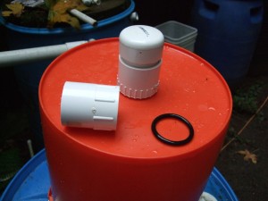 Here you are looking at the bottom of the top bucket from the outside. Note the 1/16 inch hole drilled in the 2 inch slip cap. There are 4 of them equally spaced around the cap. This makes water flow indirectly to the sand; not disturbing the schmutzdecke. The O ring actually goes on the inside of the bucket between the adapters.